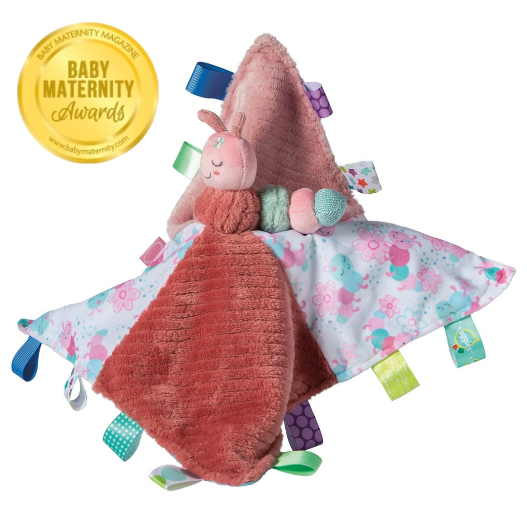 Taggies Camilla Caterpillar blanket with pink plush fabric, a caterpillar character, and colorful ribbon loops.